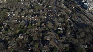 AX0171_0128 - 6.7K aerial stock footage following a road through a suburban neighborhood in Decatur, Georgia