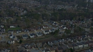 AX0171_0136 - 6.7K aerial stock footage of flying by suburban homes at sunset, Lawrenceville, Georgia