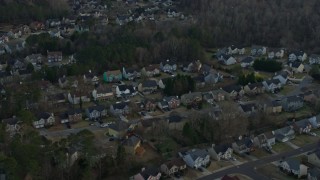 AX0171_0137 - 6.7K aerial stock footage of flying by suburban neighborhoods at sunset, Lawrenceville, Georgia