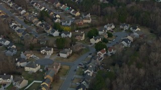 AX0171_0138 - 6.7K aerial stock footage of flying away from suburban neighborhoods at sunset, Lawrenceville, Georgia