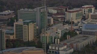 AX0171_0145 - 6.7K stock footage aerial video of buildings at the Centers for Disease Control and Prevention at sunset, Atlanta, Georgia