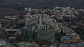 AX0171_0146 - 6.7K aerial stock footage of flying past the Centers for Disease Control and Prevention at sunset, Atlanta, Georgia