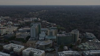 AX0171_0147 - 6.7K aerial stock footage orbit the Centers for Disease Control and Prevention at sunset, reveal Atlanta skyline, Georgia
