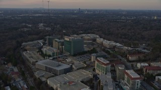 AX0171_0149 - 6.7K aerial stock footage of circling around the Centers for Disease Control and Prevention at sunset, Atlanta, Georgia