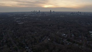 AX0171_0150 - 6.7K aerial stock footage of tilting from suburban neighborhoods to reveal Downtown and Midtown at sunset, Atlanta, Georgia