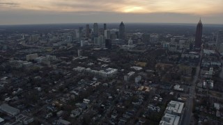 AX0171_0154 - 6.7K aerial stock footage of tilting from office and apartment buildings to reveal Downtown Atlanta at sunset, Georgia