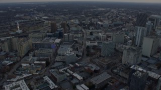 AX0171_0156 - 6.7K aerial stock footage of tilting from freeway to reveal and approach the Georgia State Capitol in Downtown Atlanta at sunset