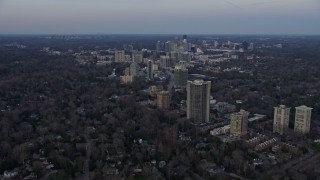 AX0171_0169 - 6.7K aerial stock footage tilt from neighborhoods, reveal Buckhead at sunset, Atlanta, Georgia