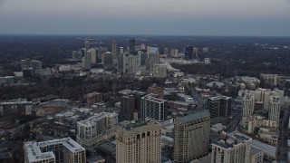 AX0171_0170 - 6.7K aerial stock footage of Buckhead skyscrapers and office buildings at sunset, Atlanta, Georgia