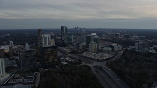 AX0171_0178 - 6.7K aerial stock footage approach Buckhead office buildings and skyscrapers at sunset, Atlanta, Georgia