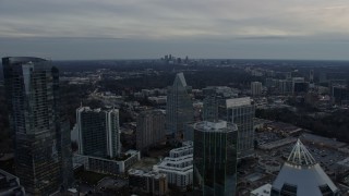 AX0171_0179 - 6.7K aerial stock footage approach and fly over Buckhead office buildings and skyscrapers at sunset, Atlanta, Georgia
