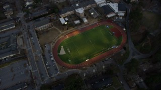 AX0171_0180 - 6.7K aerial stock footage of a high school and sports field at sunset, Atlanta, Georgia