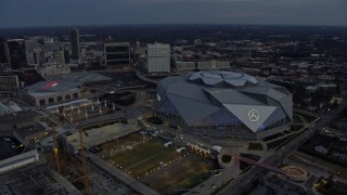 AX0171_0193 - 6.7K aerial stock footage of orbiting Mercedes-Benz Stadium at sunset in Downtown Atlanta, Georgia