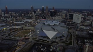 AX0171_0194 - 6.7K stock footage aerial video of orbiting Mercedes-Benz Stadium at sunset in Downtown Atlanta, Georgia
