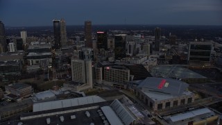 AX0171_0197 - 6.7K aerial stock footage of skyscrapers near arena and CNN Center at sunset, Downtown Atlanta, Georgia