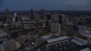 AX0171_0198 - 6.7K aerial stock footage of skyscrapers near CNN Center at sunset, Downtown Atlanta, Georgia