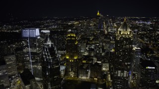 AX0171_0208 - 6.7K stock footage aerial video of flying by skyscrapers in Midtown at night, Atlanta, Georgia