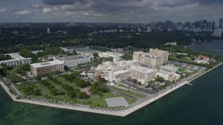 AX0172_004 - 6.7K aerial stock footage approach and orbit a waterfront hospital in Miami, Florida