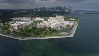 AX0172_005 - 6.7K stock footage aerial video orbit a waterfront hospital in Miami, Florida