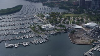 AX0172_011 - 6.7K aerial stock footage of Miami City Hall beside a marina in Miami, Florida