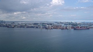 AX0172_018 - 6.7K aerial stock footage of approaching cranes and containers at the Port of Miami, Florida