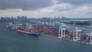 AX0172_020 - 6.7K stock footage aerial video of cruise ships docked at the Port of Miami, Florida, with the city's skyline in the background
