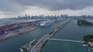 AX0172_021 - 6.7K aerial stock footage of following MacArthur Causeway toward cruise ships at Port of Miami, Florida