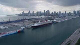 AX0172_022 - 6.7K stock footage aerial video of following MacArthur Causeway past cruise ships at Port of Miami, Florida