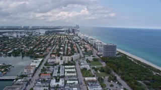 AX0172_026 - 6.7K aerial stock footage fly over beach for view of coastal town of Surfside, Florida