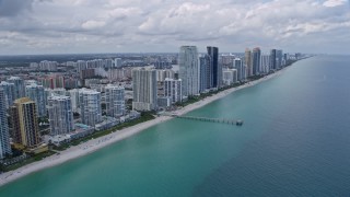 AX0172_031 - 6.7K aerial stock footage flyby beachfront condo high-rise for view of beach and more condos in Sunny Isles Beach, Florida
