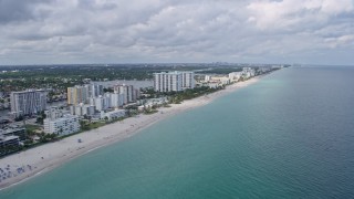 AX0172_035 - 6.7K aerial stock footage of flying by beachside coastal communities of Hallandale Beach and Hollywood, Florida