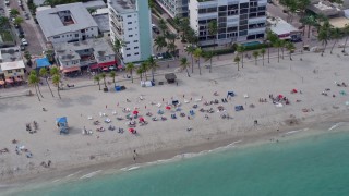 AX0172_036 - 6.7K aerial stock footage of sunbathers enjoying the beach in Hollywood, Florida