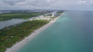 AX0172_037 - 6.7K aerial stock footage of following the beach toward coastal homes in Hollywood, Florida