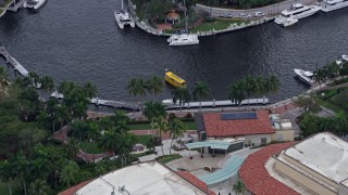 AX0172_056 - 6.7K aerial stock footage of a ferry sailing toward a dock in Downtown Fort Lauderdale, Florida