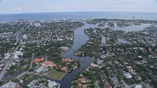 AX0172_059 - 6.7K aerial stock footage tilt from yachts on New River in Downtown Fort Lauderdale, Florida, reveal coastal neighborhoods