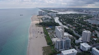 AX0172_064 - 6.7K stock footage aerial video of flying over the beach toward condos and resorts in Fort Lauderdale, Florida