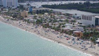 AX0172_068 - 6.7K stock footage aerial video of flying past hotels and crowded beaches in Hollywood, Florida