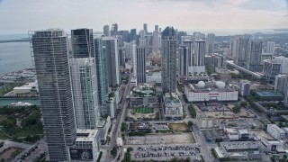 AX0172_088 - 6.7K aerial stock footage tilt from freeway by performing arts center, reveal skyscrapers in Downtown Miami, Florida