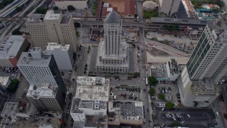AX0172_092 - 6.7K aerial stock footage approach the Miami-Dade County Courthouse, tilt to bird's eye view in Downtown Miami, Florida