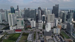 AX0172_105 - 6.7K aerial stock footage tilt from Little Havana street, reveal and fly over skyscrapers and city buildings, Downtown Miami, Florida