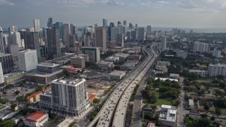 AX0172_111 - 6.7K aerial stock footage of heavy traffic on I-95 and tall skyscrapers in Downtown Miami, Florida