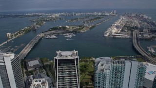 AX0172_116 - 6.7K aerial stock footage tilt from skyscrapers in Downtown Miami, Florida, reveal islands in the bay