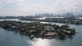 AX0172_125 - 6.7K stock footage aerial video of flying by waterfront mansions on islands in Miami, Florida