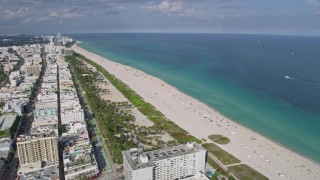 AX0172_131 - 6.7K aerial stock footage of the Atlantic Ocean and beach park in South Beach, Miami, Florida