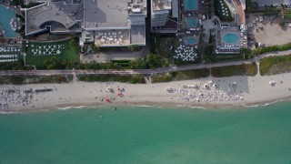 AX0172_136 - 6.7K stock footage aerial video a view of a bird's eye view of sunbathers in South Beach, Miami, Florida