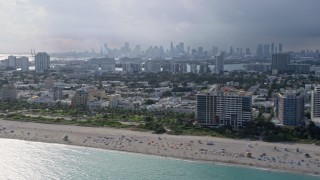 AX0172_142 - 6.7K aerial stock footage of flying by South Beach, Florida with the Miami skyline in the distance