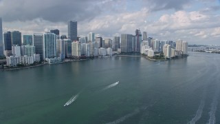 AX0172_152 - 6.7K aerial stock footage tilt from the bay to Downtown Miami skyscrapers and Brickell Key in Florida