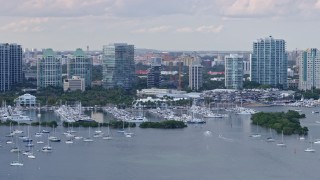 AX0172_157 - 6.7K stock footage aerial video of flying by a marina and condominium complexes, Miami, Florida