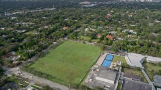 AX0172_161 - 6.7K aerial stock footage of players on a high school soccer field in Pinecrest, Florida