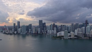 AX0172_165 - 6.7K stock footage aerial video approach the Downtown Miami skyline and Brickell Key, Florida at sunset